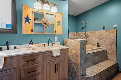 a bathroom with two sinks and a tub at Relaxing Pocono Stay Near Lake with Hot Tub & BBQ in Blakeslee