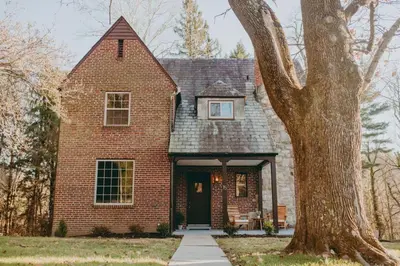 a brick house with a tree in front of it at The Minimalist Retreat in Conestoga