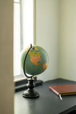 a globe sitting on a table next to a notebook at The Minimalist Retreat in Conestoga