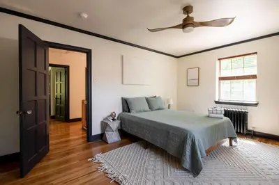 a bedroom with a bed and a ceiling fan at The Minimalist Retreat in Conestoga
