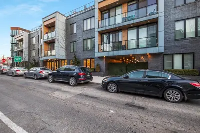 a row of cars parked on the side of a street at Bright Studio Haven - Pool, Gym & Balcony Views in Philadelphia