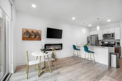 a kitchen and dining room with a table and chairs at Sleek 1BR Hideaway - Gym, Pool Balcony in Philadelphia