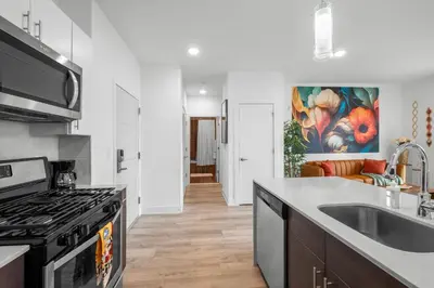 a kitchen with a sink and a stove at Sleek 1BR Hideaway - Gym, Pool Balcony in Philadelphia