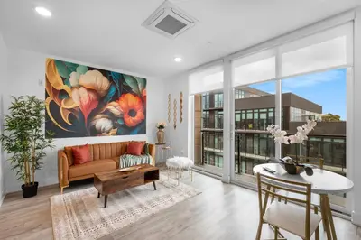 a living room with a couch and a table at Sleek 1BR Hideaway - Gym, Pool Balcony in Philadelphia