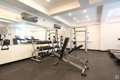 a room with a gym with treadmills and weights at Bright 1BR Haven - Balcony Skyline Views in Philadelphia