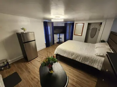 a small room with a bed and a table at Private Room - Shared Bathroom in Perth Amboy