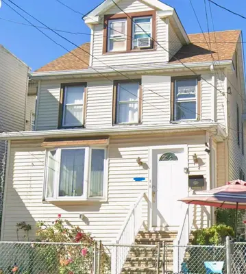 a white house with a white door at Private Room - Shared Bathroom in Perth Amboy