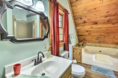 a bathroom with a sink and a toilet and a tub at Log Cabin and Suite, Friendly Retreat Close to Skiing in Pleasant Mount