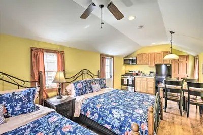 a bedroom with two beds and a kitchen at Log Cabin and Suite, Friendly Retreat Close to Skiing in Pleasant Mount
