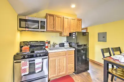 a kitchen with a stainless steel stove and refrigerator at Log Cabin and Suite, Friendly Retreat Close to Skiing in Pleasant Mount