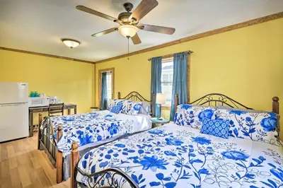 a bedroom with two beds and a ceiling fan at Family Cabin and Suites Close to Ski Adventures in Pleasant Mount