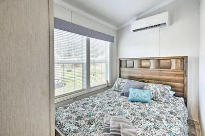 a bedroom with a bed and a window at Log Cabin and Cottage Near Elk Mountain Ski Slopes in Pleasant Mount