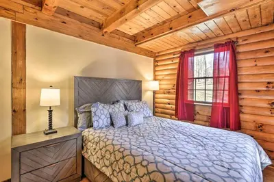 a bedroom with a bed and a window at Log Cabin and Suite Close to Ski Adventures in Pleasant Mount