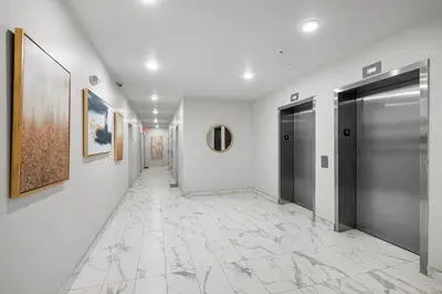 a hallway with two doors and a tile floor at Stylish Studio - Pool, Gym & Balcony Bliss in Philadelphia