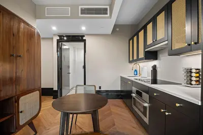 a kitchen with a wooden table and a wooden counter top at Freeman 303 by Rove Travel - 1BR Condo with Shared Amenities in New York