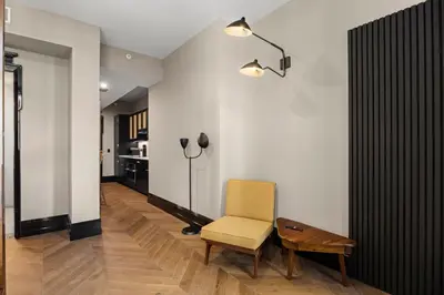 a living room with a chair and a table at Freeman 401 by Rove Travel - Studio w Shared Amenities in New York