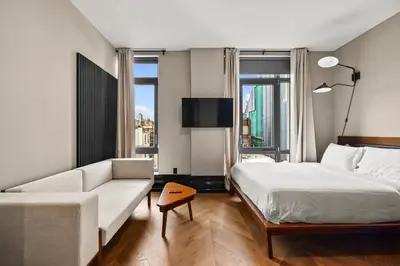 a hotel room with a bed and a couch at Freeman 601 by Rove Studio with Shared Amenities in New York