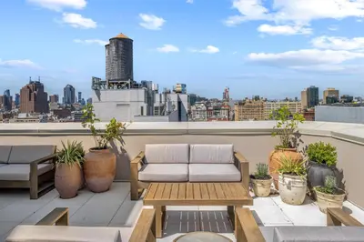 a balcony with a couch and a view of a city at Freeman 601 by Rove Studio with Shared Amenities in New York