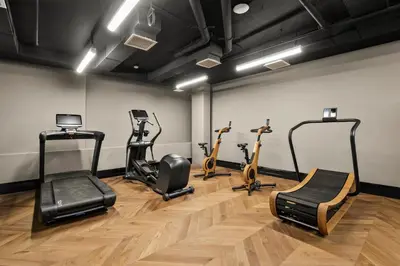 a gym with treadmills and exercise bikes in a room at Freeman 901 by Rove Travel - Studio with Shared Amenities in New York