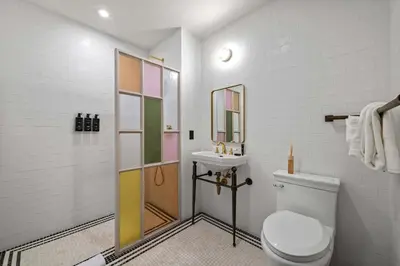 a bathroom with a toilet and a sink at Freeman 203 by Rove Travel -1BR Condo with Shared Amenities in New York