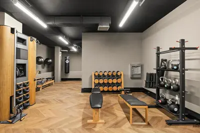 a room with a gym with dumbbells on the wall at Freeman 503 by Rove Travel - 1BR Condo with Shared Amenities in New York
