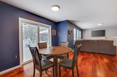 a dining room with a table and chairs and a couch at Poconos Retreat Hot Tub, Pool, Theater EV chrg & more in Blakeslee
