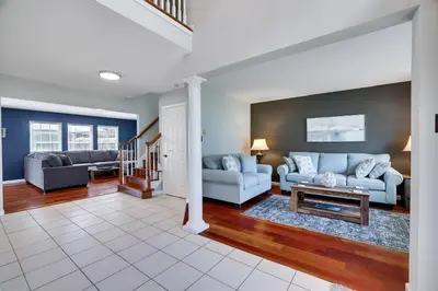 a living room with a couch and a table at Poconos Retreat Hot Tub, Pool, Theater EV chrg & more in Blakeslee