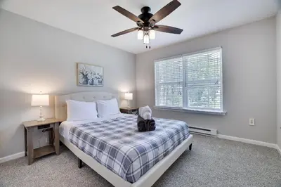 a bedroom with a bed and a ceiling fan at Poconos Retreat Hot Tub, Pool, Theater EV chrg & more in Blakeslee