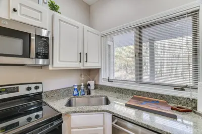 a kitchen with a sink and a microwave at Steps to Lake Tanglwood Tranquil Wooded Retreat in Greentown