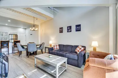 a living room with a couch and a table at Steps to Lake Tanglwood Tranquil Wooded Retreat in Greentown