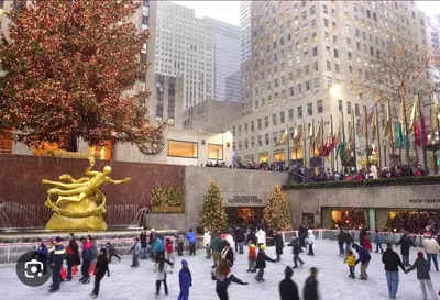 a group of people walking around a plaza with christmas trees at Superb 4-bedroom apartment 1 block from Central Park in vibrant New York City in New York