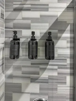 a bathroom with three bottles of soap on a wall at Superb 4-bedroom apartment 1 block from Central Park in vibrant New York City in New York