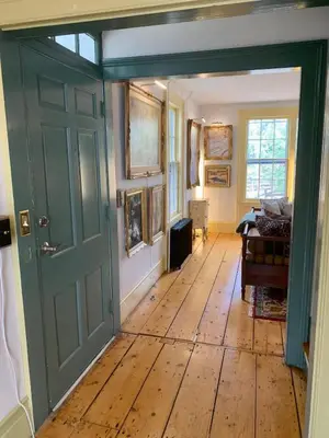 a room with a green door and a wooden floor at Historic Canal Home on Nature Preserve in Princeton