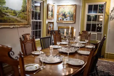 a dining room with a table with plates and glasses at Historic Canal Home on Nature Preserve in Princeton