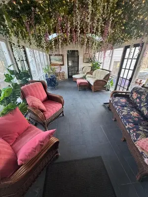 a living room with couches and chairs and plants at Historic Canal Home on Nature Preserve in Princeton