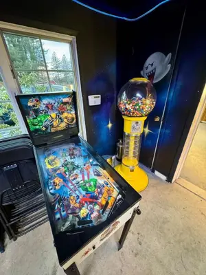 a pinball game in a room with a claw machine at Private Luxurious Canal Estate in Princeton