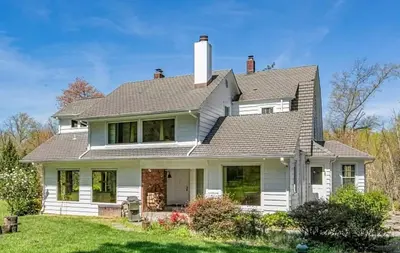 a white house with a gray roof at Private Luxurious Canal Estate in Princeton