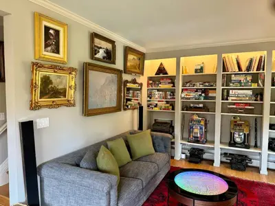 a living room with a couch and book shelves at Private Luxurious Canal Estate in Princeton