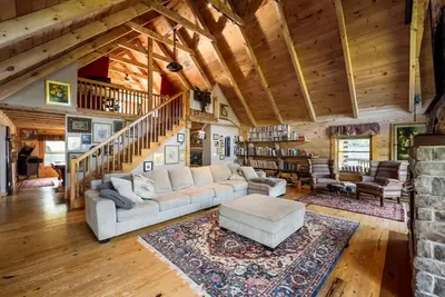 a living room with a white couch and a staircase at Private Luxury Log Cabin in New Hope