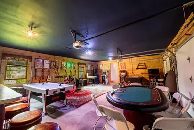 a room with a ping pong table and chairs at Private Luxury Log Cabin in New Hope
