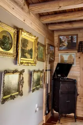 a wall with paintings and pictures on the wall at Private Luxury Log Cabin in New Hope