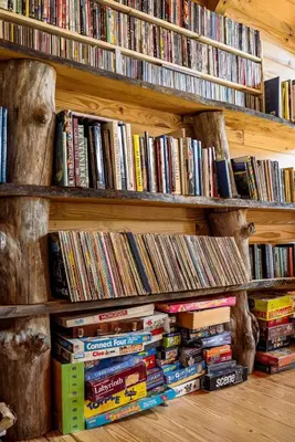a book shelf filled with lots of books at Private Luxury Log Cabin in New Hope