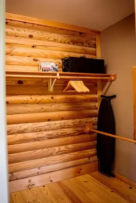 a room with a wooden wall with a shelf at Private Luxury Log Cabin in New Hope