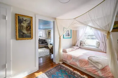 a bedroom with a bed with a canopy at Charming & Whimsical Historic River Home in Titusville