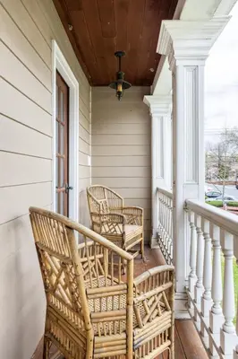 a porch with wicker chairs and a ceiling at Unique Luxury Central Historic Landmark Home in Lambertville
