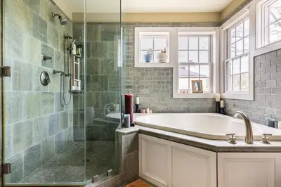 a bathroom with a tub and a glass shower at Unique Luxury Central Historic Landmark Home in Lambertville