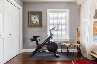 a room with a exercise bike and a bed at Unique Luxury Central Historic Landmark Home in Lambertville