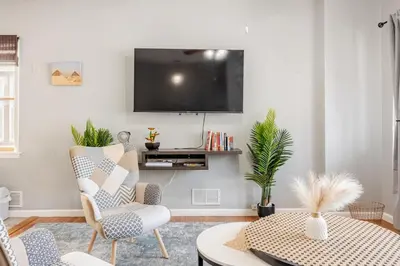 a living room with a flat screen tv on the wall at Free Parking -5 Guests- 30 min to NYC in Bayonne
