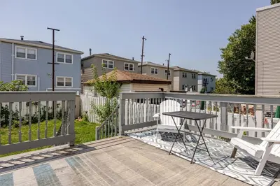 a balcony with a table and chairs and a fence at Free Parking -5 Guests- 30 min to NYC in Bayonne
