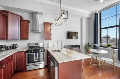 a kitchen with a sink and a stove top oven at Sleek NoLibs 1BR - Pool & Gym in Philadelphia